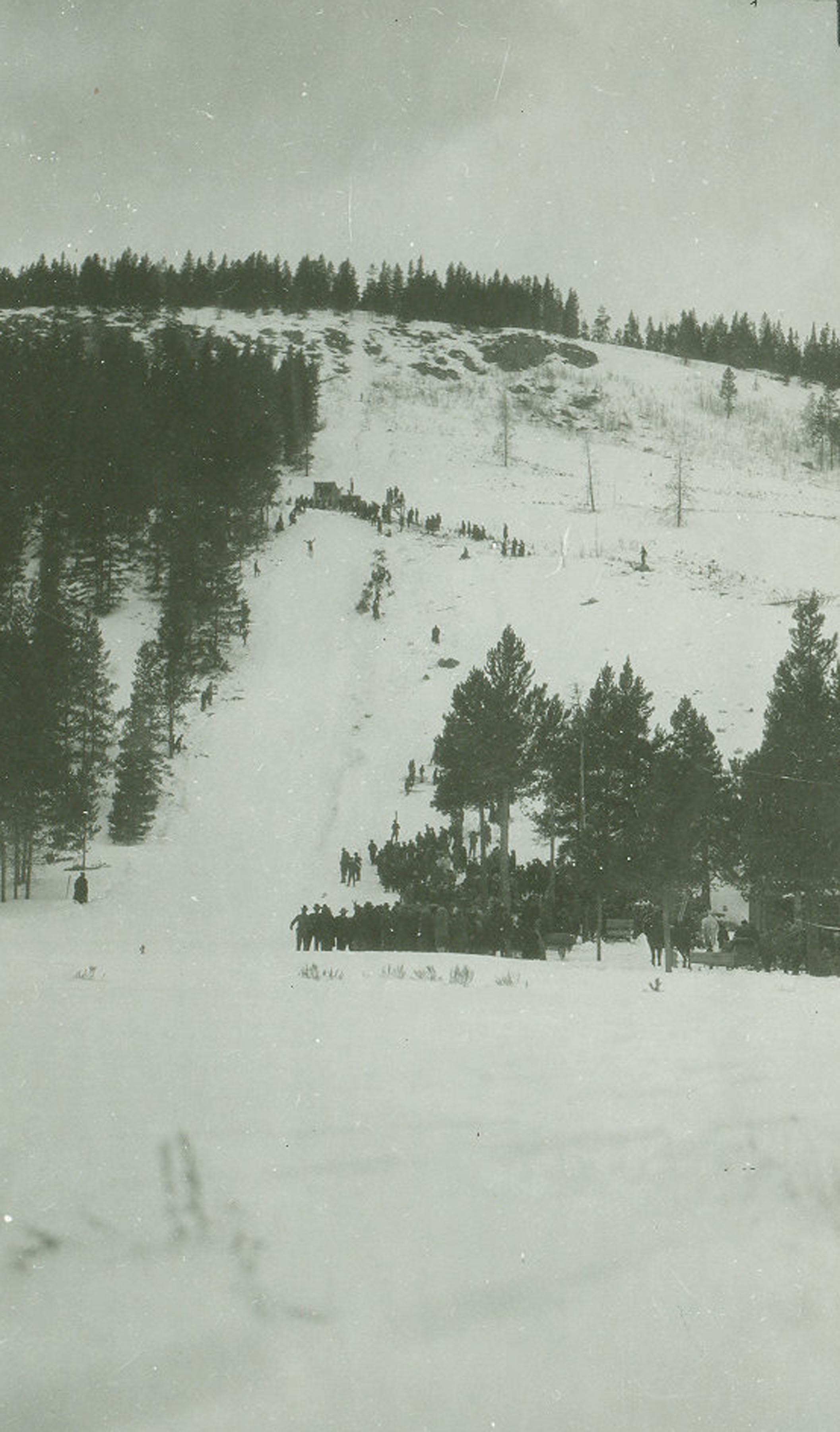 Spectators watch Anders Haugen make a jump at the Prestrud Jump, also called Haugen's Hill, at Dillon in 1919 or 1920. 